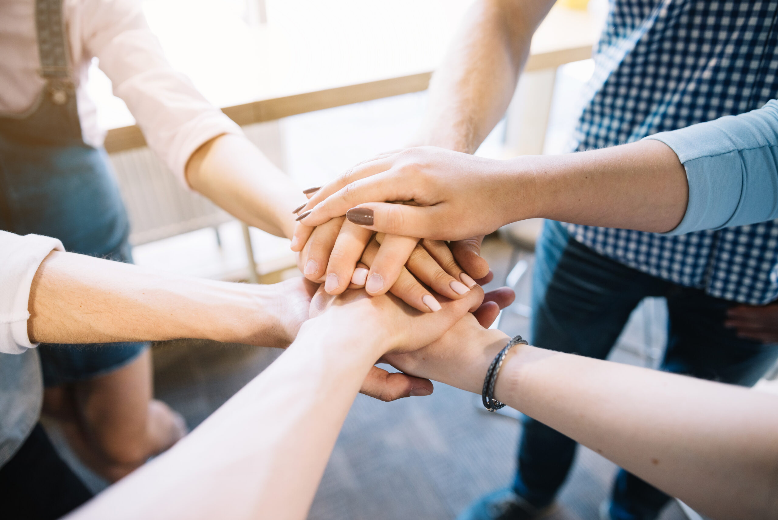 crop-colleagues-holding-hands-together
